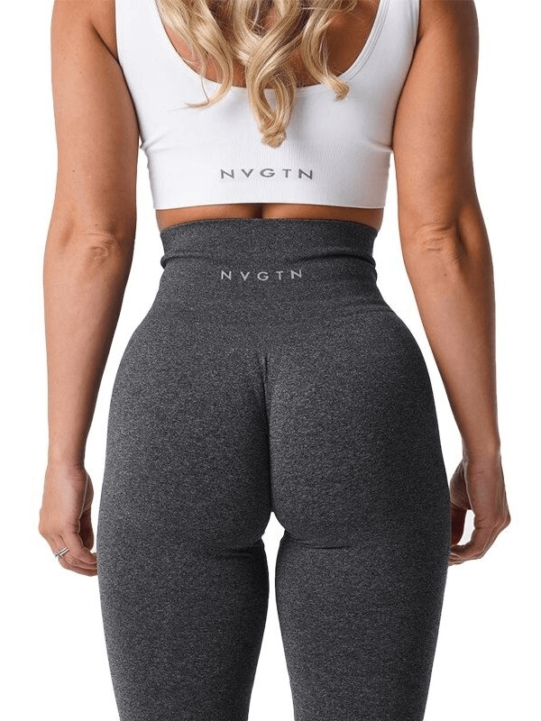 Back view of a woman wearing gray high-waisted fitness leggings and a white crop top, showcasing a stylish gym outfit.